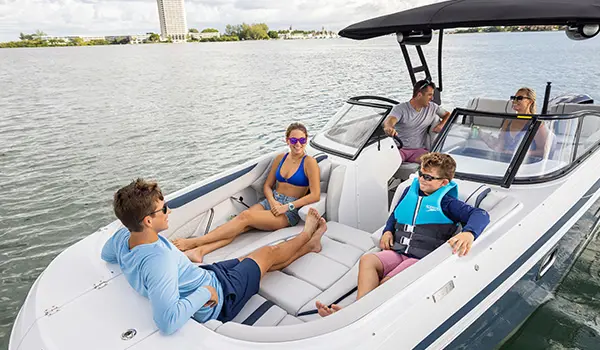 Family relaxing on the bow seats on a Hurricane Sundeck 2600 OB deck boat.