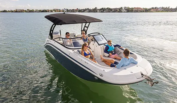 Family floating on the ocean on a Hurricane Sundeck 2600 OB deck boat.