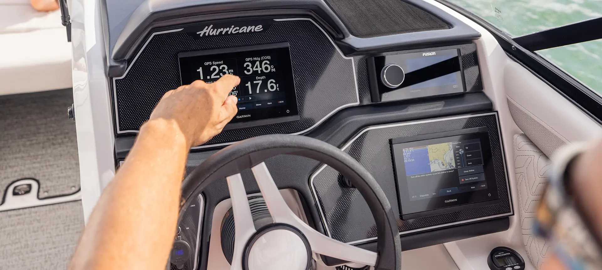 Garmin digital GPS and gauges on the helm of a Hurricane Sundeck 2600 OB deck boat.