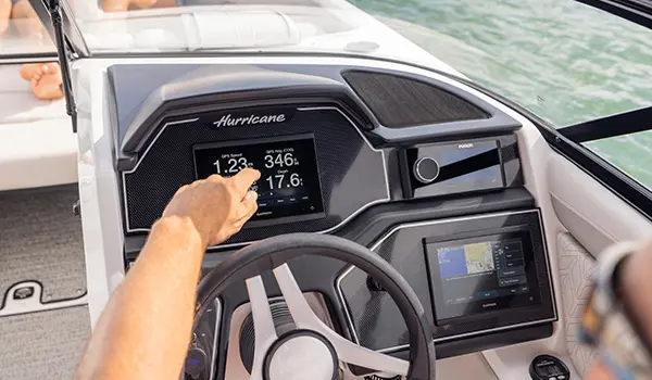 Garmin digital GPS and gauges on the helm of a Hurricane Sundeck 2600 OB deck boat.