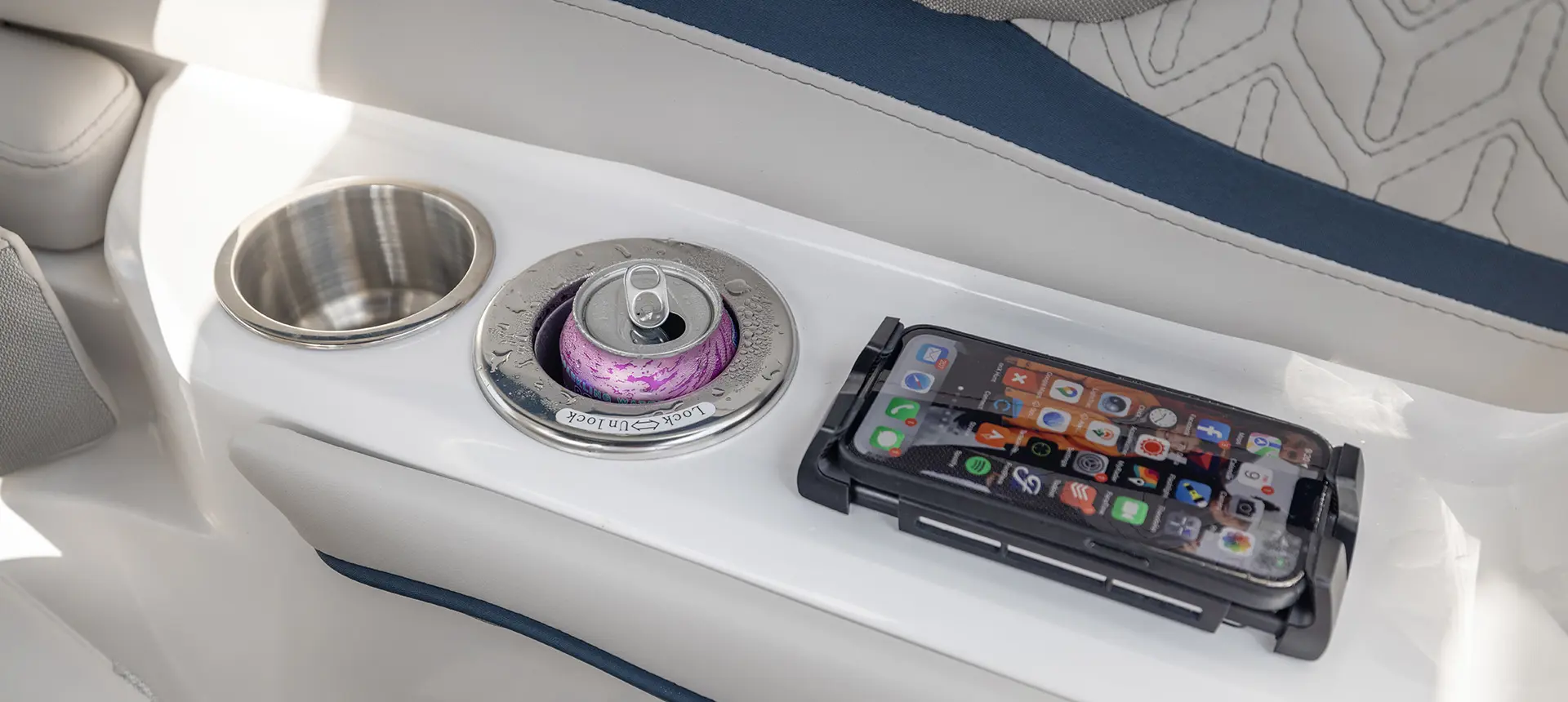 Integrated cup holders and wireless charging pad on the helm of a Hurricane Sundeck 2600 OB Deck Boat.