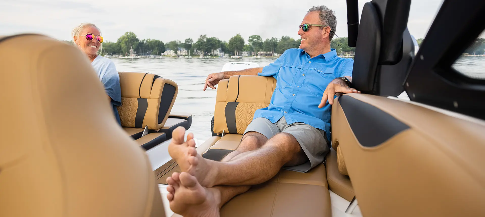 man relaxing on the stern swingback seat on a hurricane sundeck 2600 ob deck boat