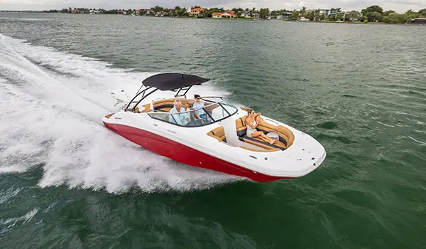 side-aerial view of a family on a hurricane sundeck 2690 ob deck boat while cruising on the ocean