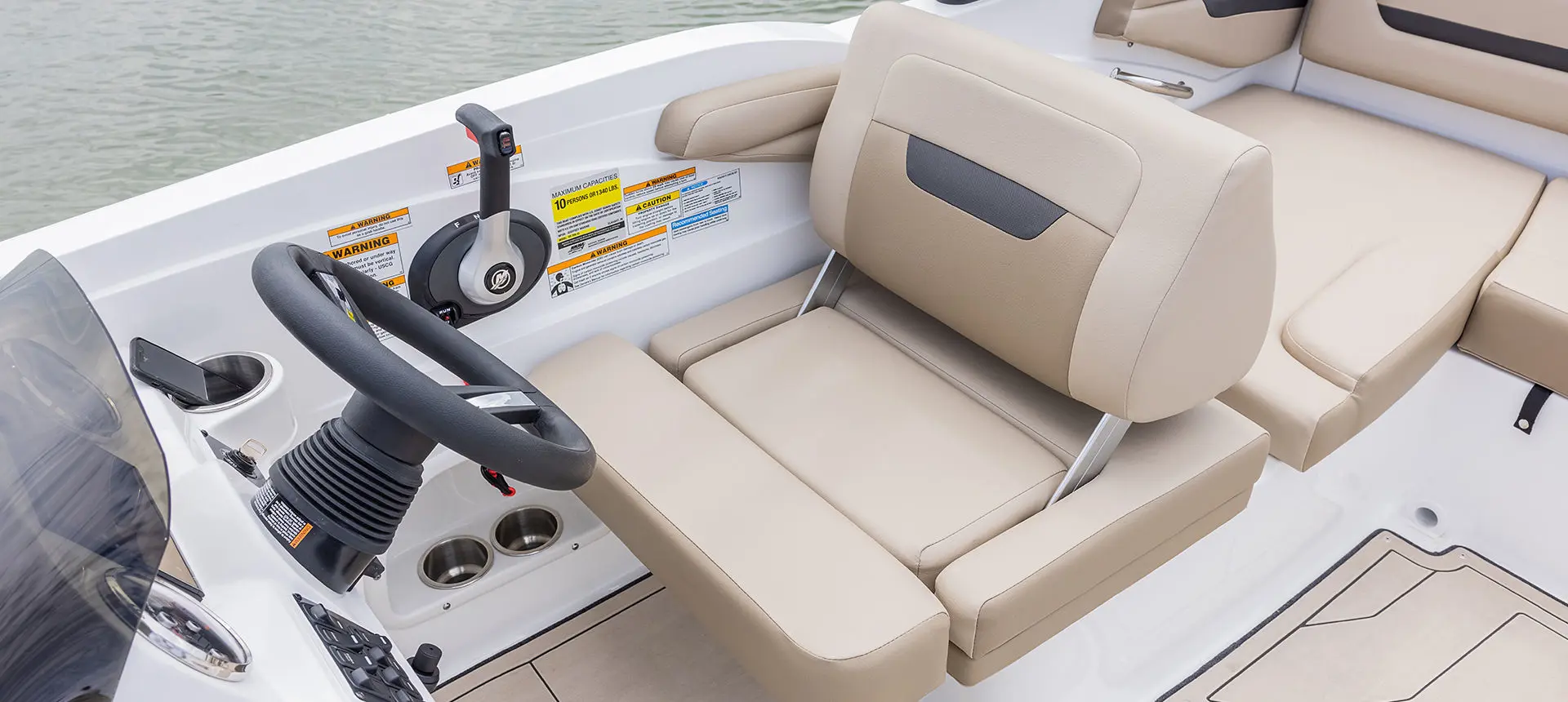 Captain's seat at the helm of a Hurricane SunDeck Sport I/O deck boat.