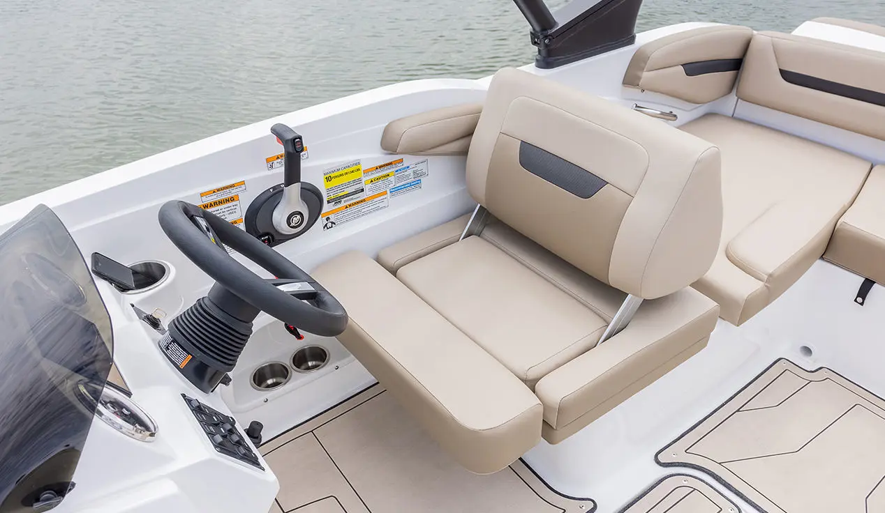 Captain's seat at the helm of a Hurricane SunDeck Sport I/O deck boat.