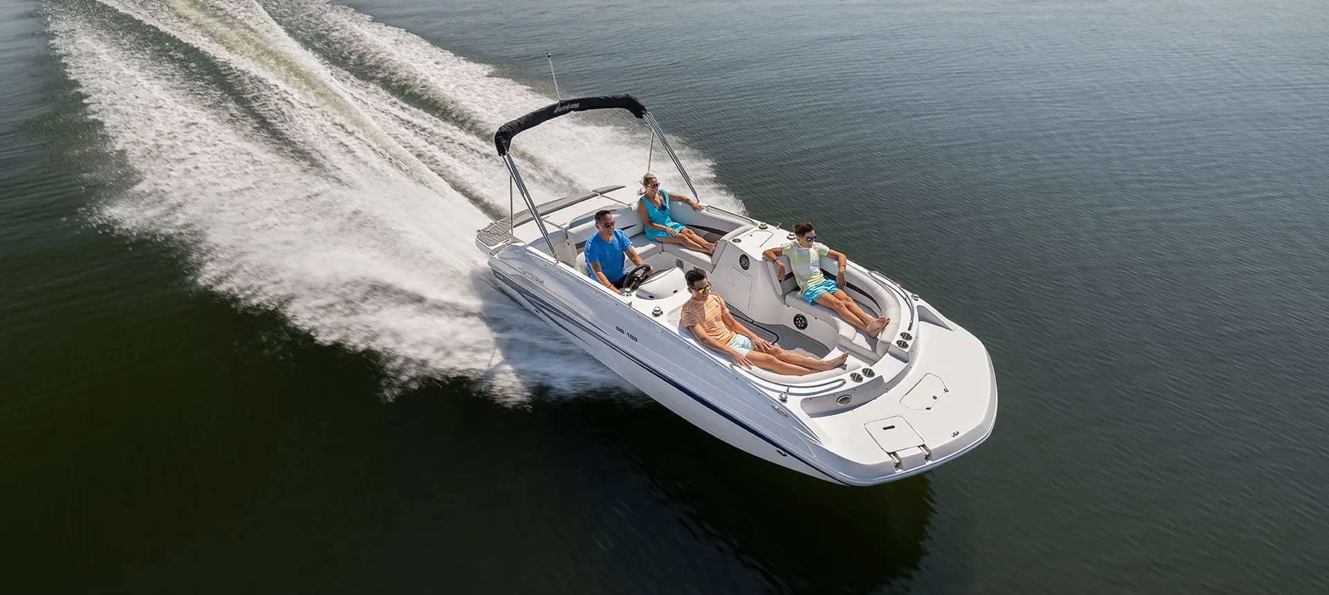 Aerial view of a family cruising on a Hurricane SunDeck Sport 188 IO deck boat.
