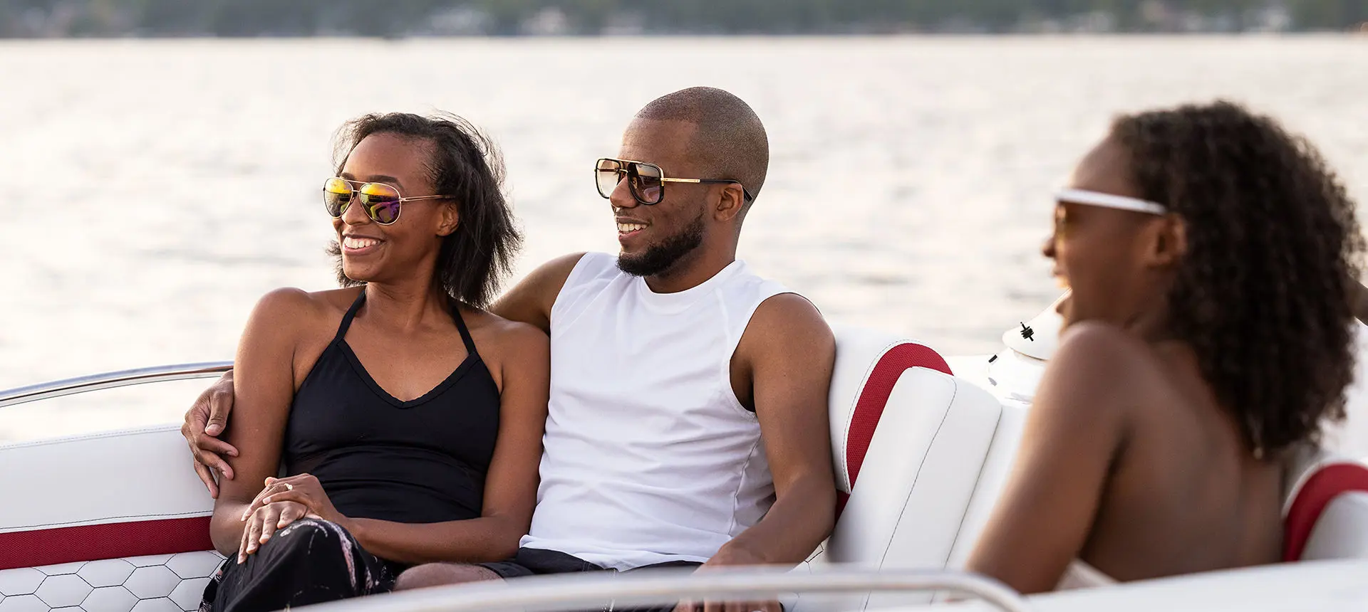 family relaxing on a hurricane sundeck sport ob boat