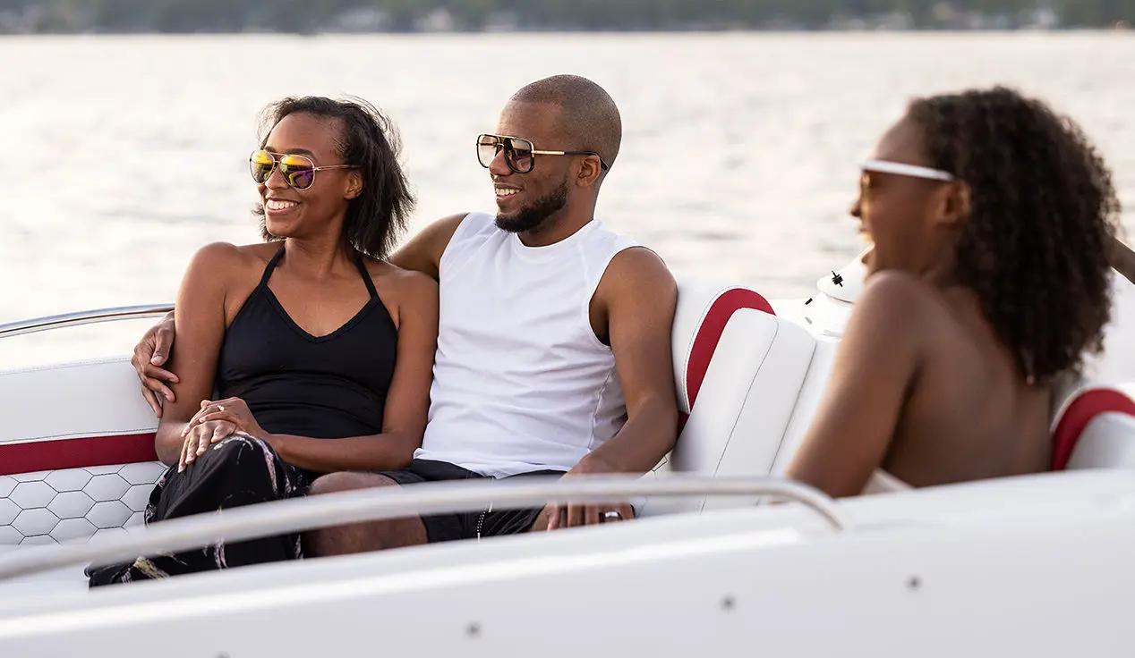 family relaxing on a hurricane sundeck sport ob boat