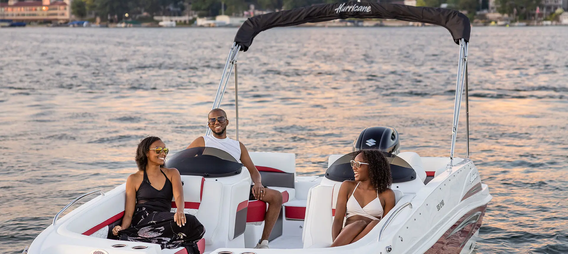 family smiling at each other on a hurricane sundeck sport ob boat