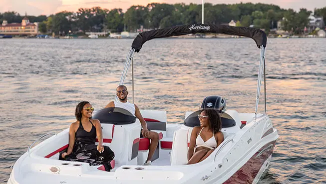family smiling at each other on a hurricane sundeck sport ob boat