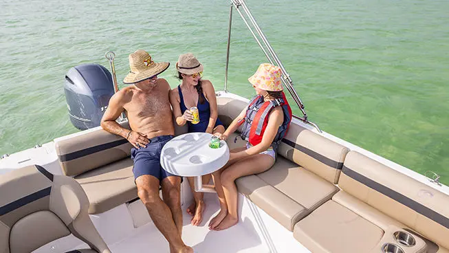 family sitting on the stern couch on a hurricane sundeck sport ob boat