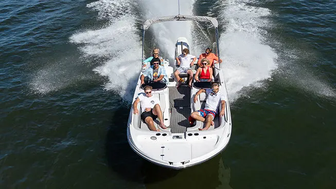 fully loaded hurricane sundeck sport ob boat driving on a lake