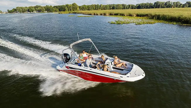 Family on a red Hurricane SunDeck Sport OB boat.
