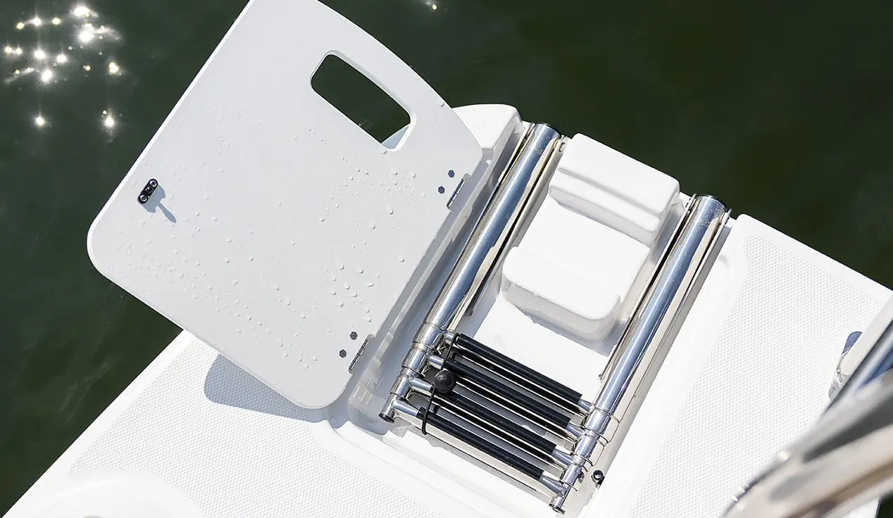 Folding ladder on the stern of a Hurricane SunDeck Sport OB boat.