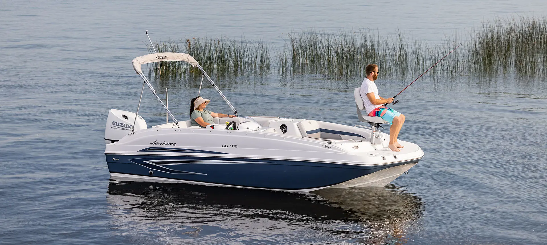 Man fishing off the bow of a Hurricane SunDeck Sport 188 OB deck boat.
