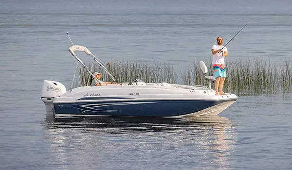 Man casting off the bow of a Hurricane SunDeck Sport 188 OB deck boat.
