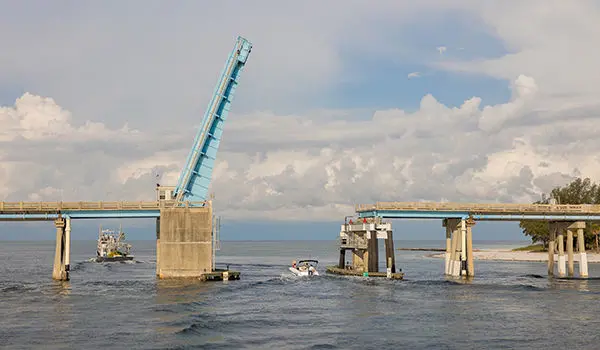 rear view of a hurricane sport 201 ob deck boat going under a bridge