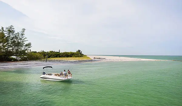 long distance view of a family fishing on a hurricane sport 201 ob deck boat on the ocean