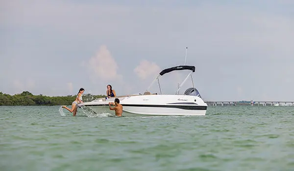 girl splashing water off the bow on a hurricane sport 201 ob deck boat