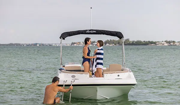 mother smiling at daughter on a hurricane sport 201 ob deck boat
