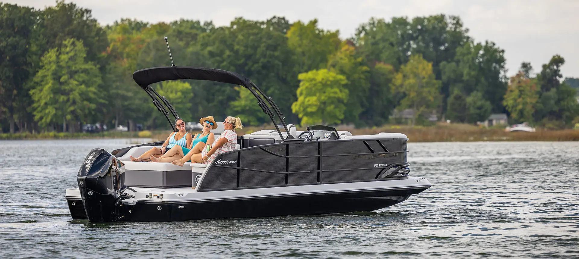 A happy couple sailing the water on their boat