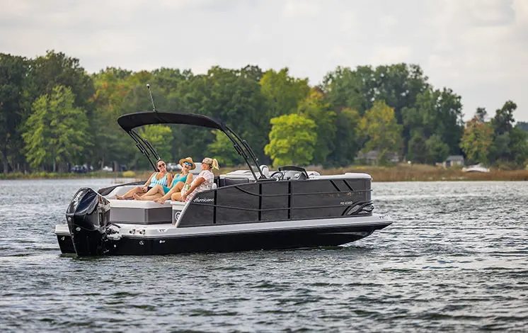 A happy couple sailing the water on their boat
