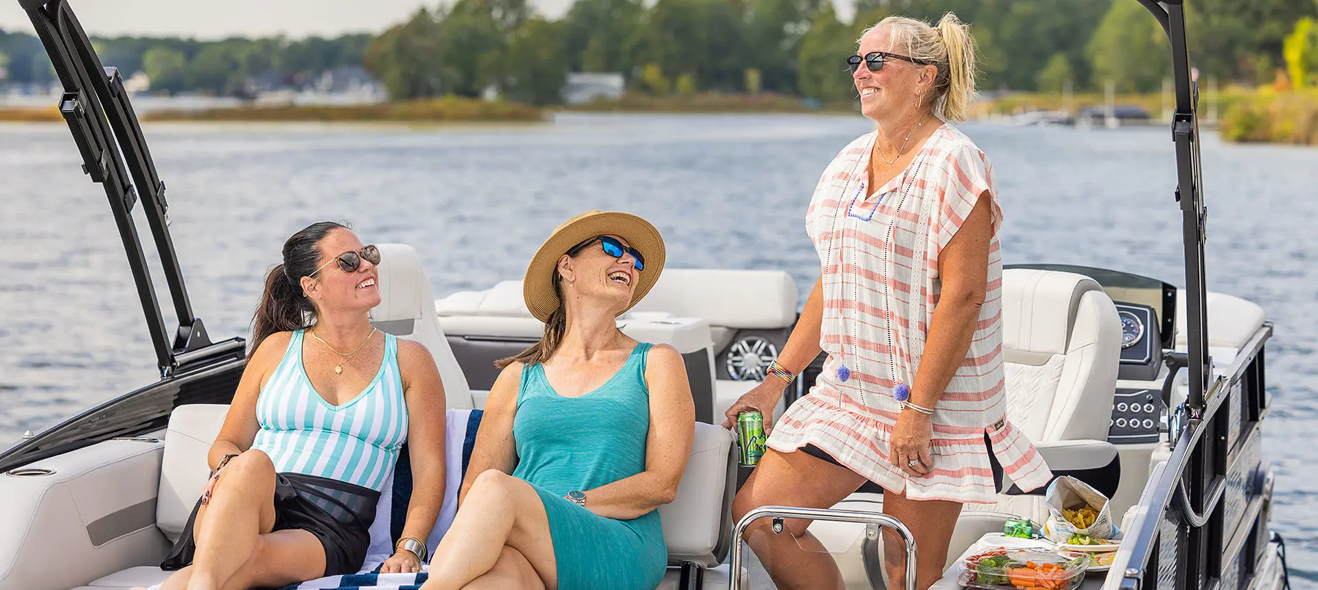 Three friends chatting next to their Hurricane boat