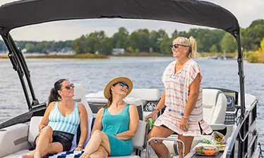 Three friends chatting next to their Hurricane boat