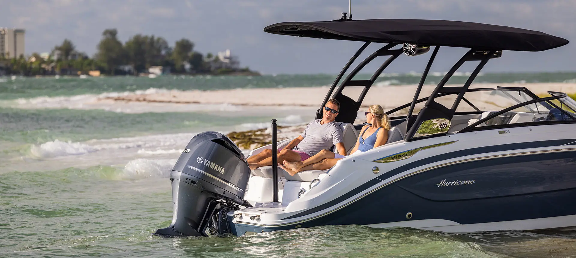 Couple relaxing on the stern seats on a Hurricane deck boat.