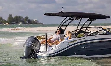 couple relaxing on the stern seats on a hurricane deck boat