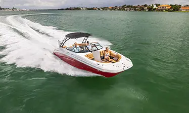 Family on a Hurricane Center Console boat speeding across the ocean.
