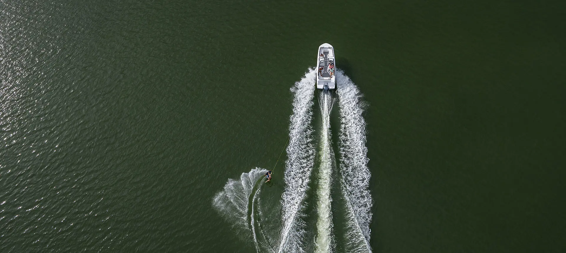 a hurricane sport boat pulling a wake boarder