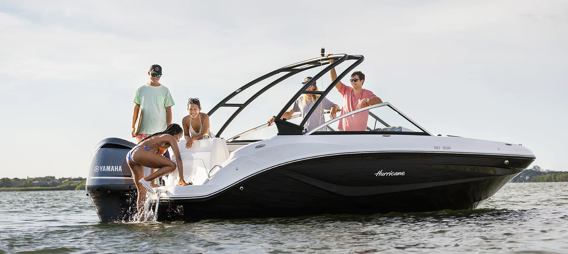 girl using a ladder onto a hurricane sport boat