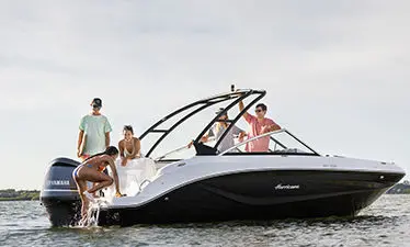 girl using a ladder onto a hurricane sport boat