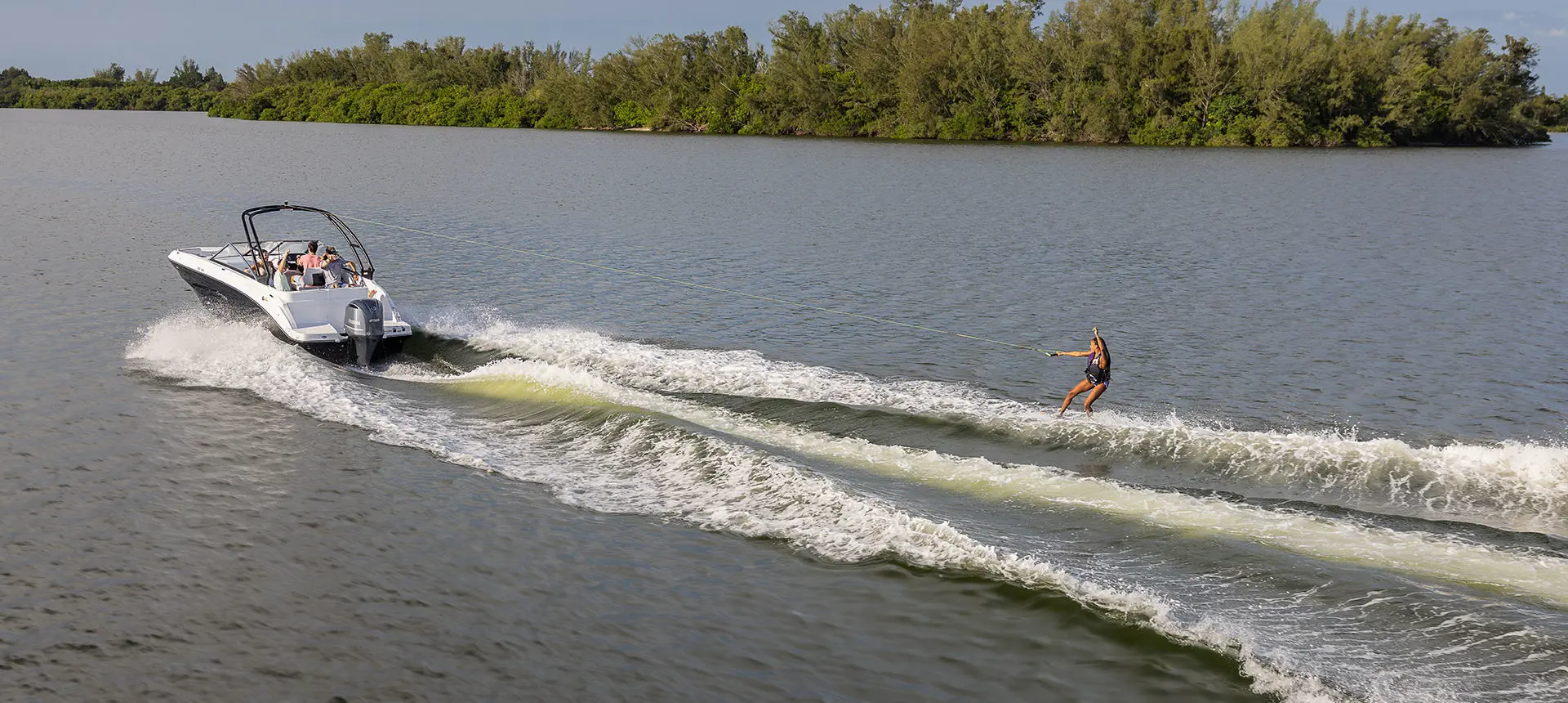 girl wake boarding behind a hurricane sport boat