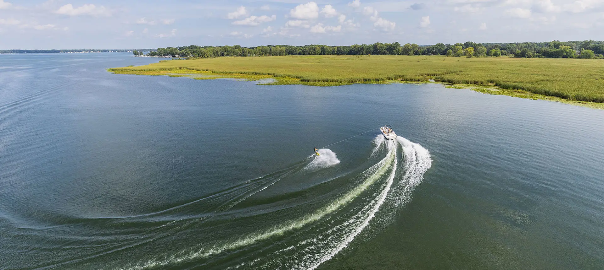 aerial view of a wake boarder behind a hurricane sport boat