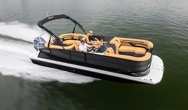 Side view of a Hurricane FunDeck 2360 SBC OB speeding across lake.