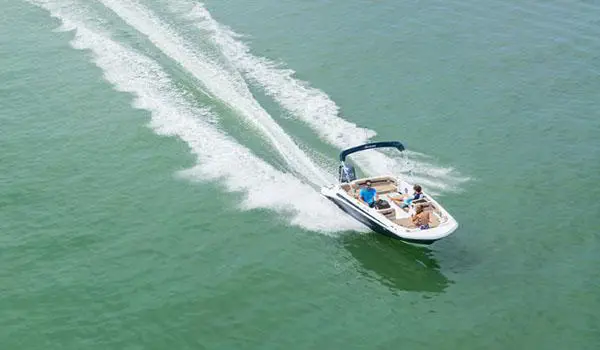 Aerial view of a Hurricane SunDeck Sport 185 OB deck boat on a lake.