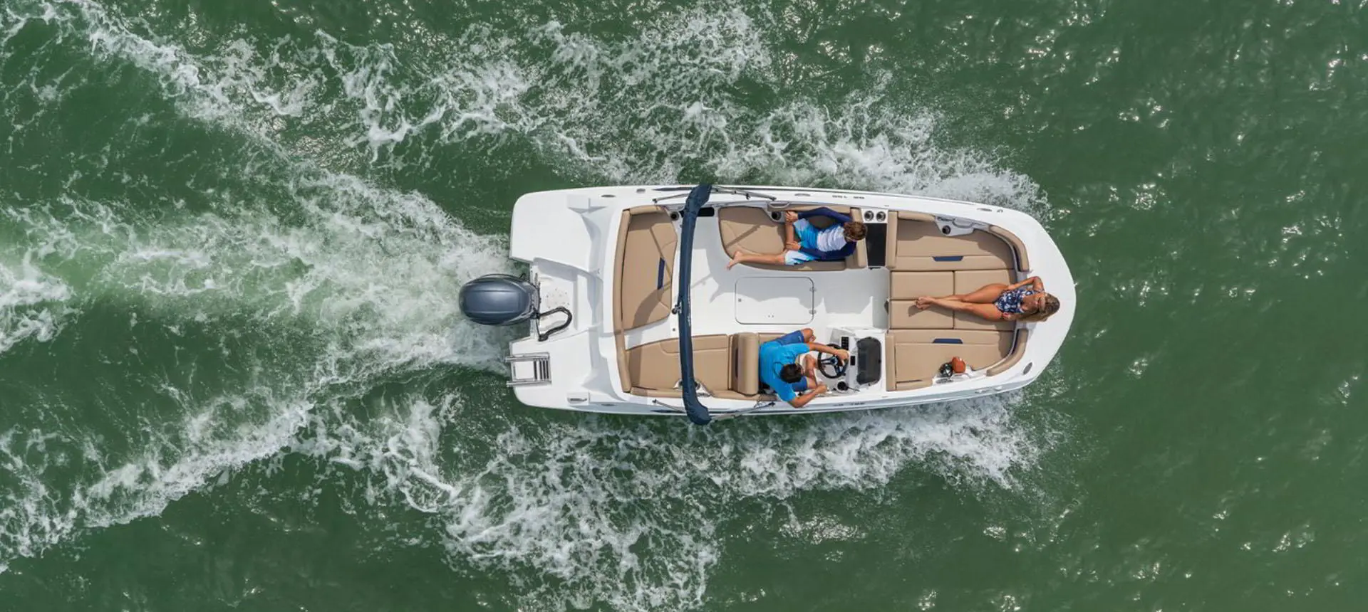 Overhead view of people relaxing on a Hurricane SunDeck Sport 185 OB deck boat.