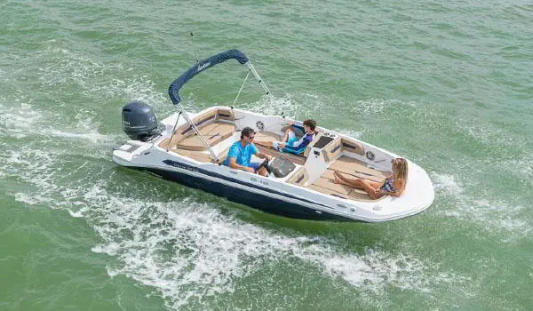 3 people enjoying the lake on a Hurricane SunDeck Sport 185 OB deck boat.