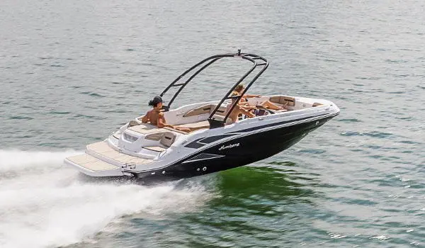 Stern focused view of a Hurricane SunDeck Sport 205 IO deck boat cruising on a lake.