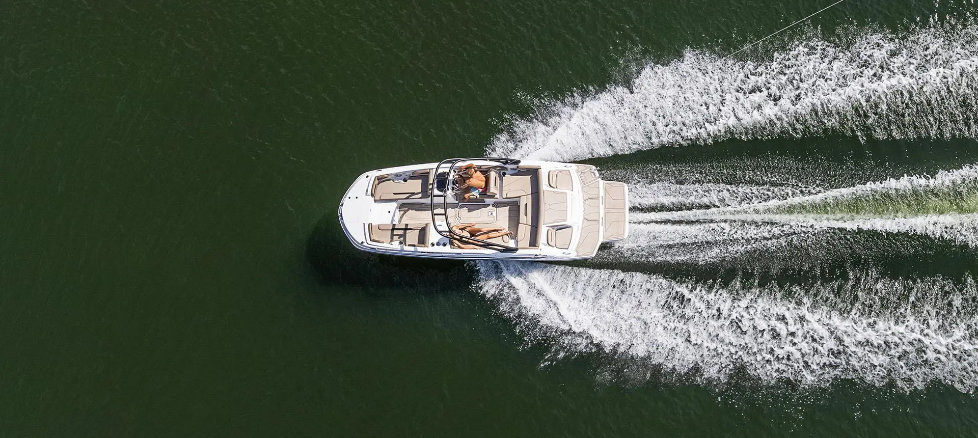 Aerial view of a Hurricane SunDeck Sport 205 IO deck boat on a lake.