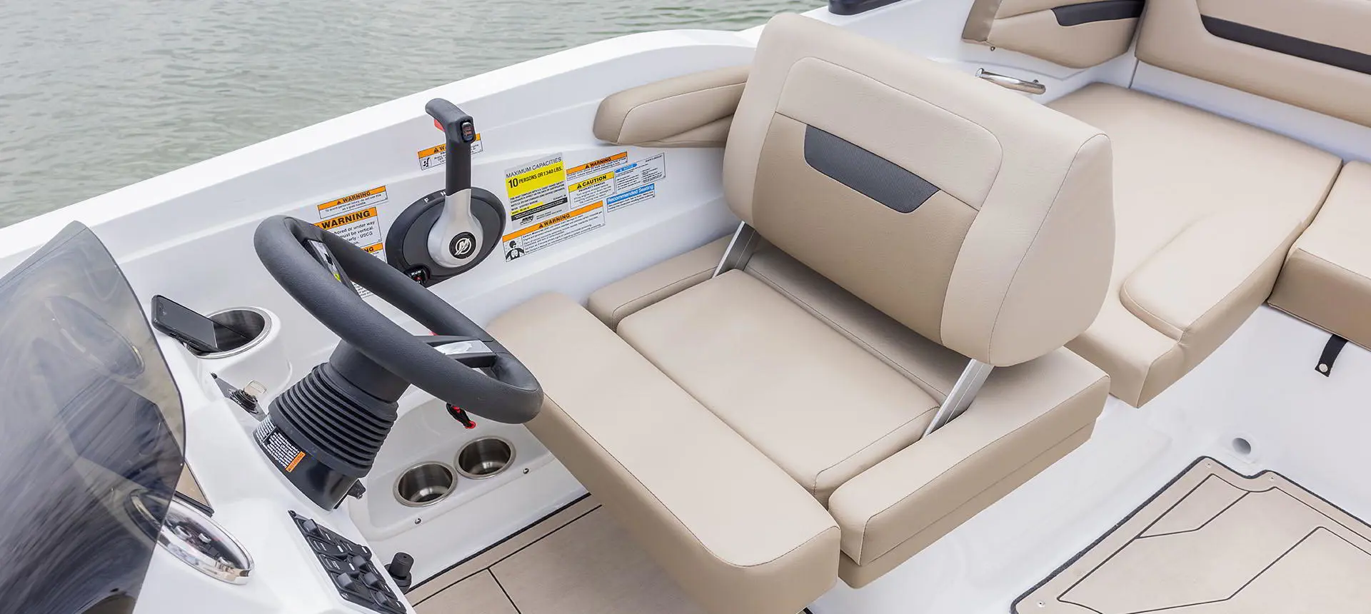 Captain's helm and chair on a Hurricane SunDeck Sport 205 IO deck boat.
