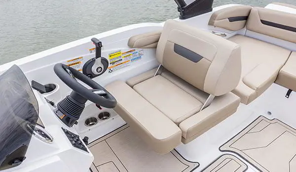 Captain's helm and chair on a Hurricane SunDeck Sport 205 IO deck boat.