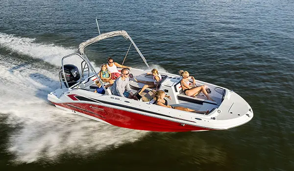 A family cruising the lake on their Hurricane SunDeck Sport 205 OB deck boat.