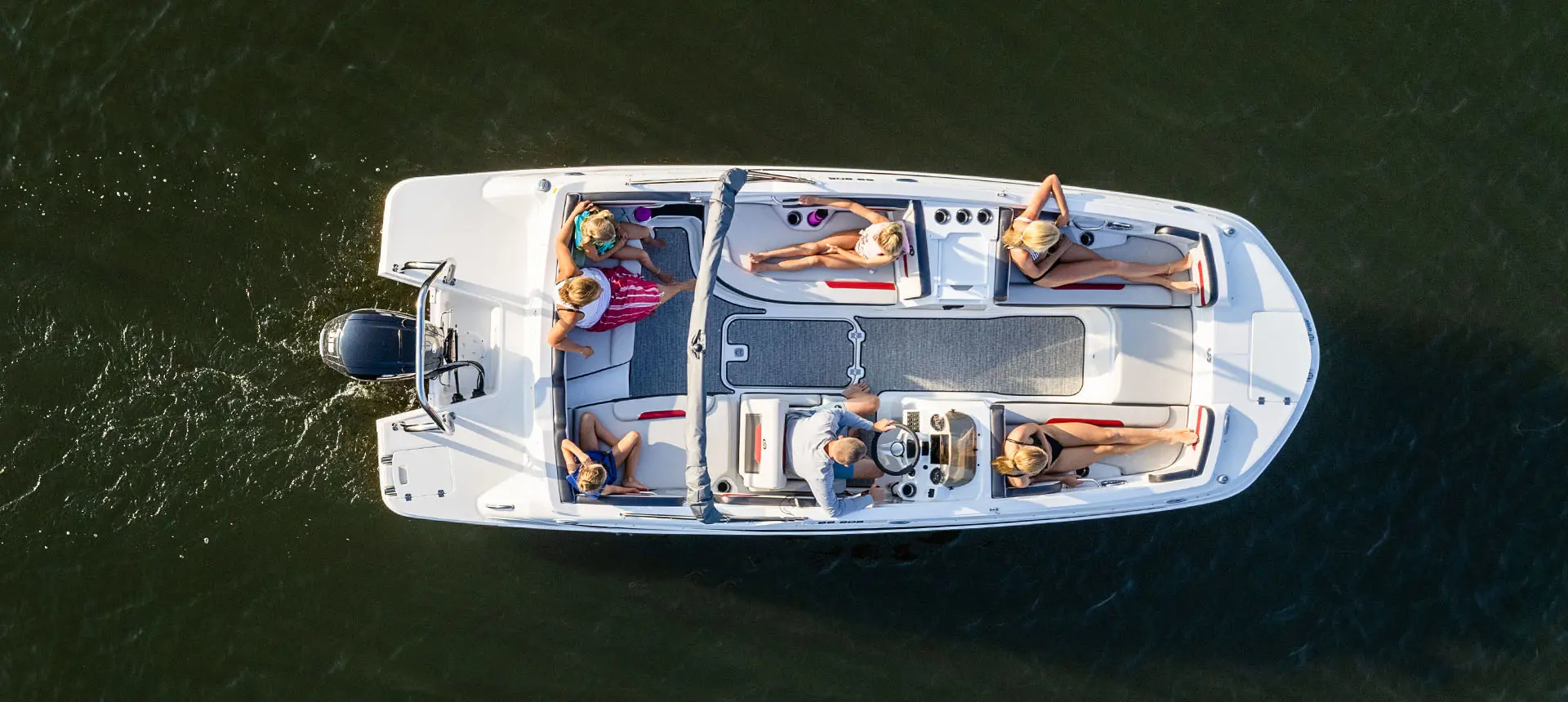 Aerial view of 7 people relaxing on a Hurricane SunDeck Sport 205 OB deck boat.