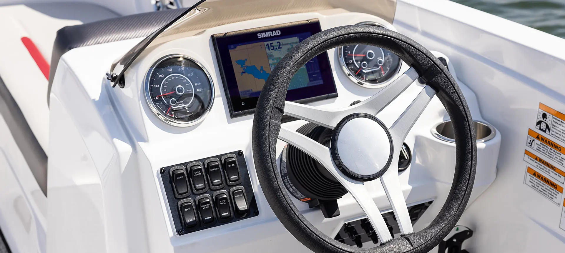 The helm of a Hurricane SunDeck Sport 205 OB deck boat.