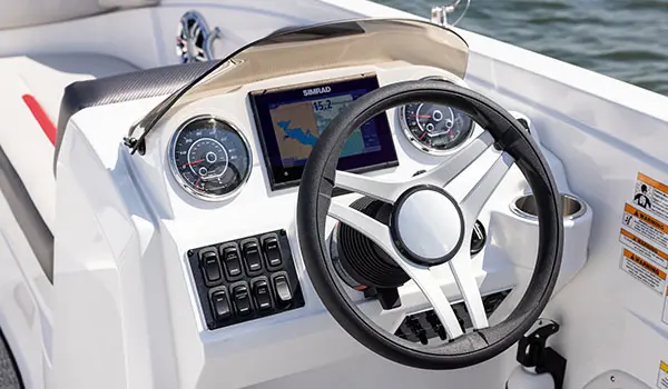 The helm of a Hurricane SunDeck Sport 205 OB deck boat.