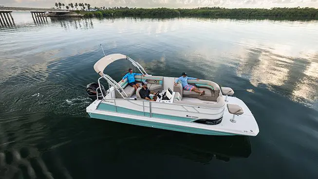 overhead view of a man at the helm and his friends relaxing on a hurricane fundeck boat