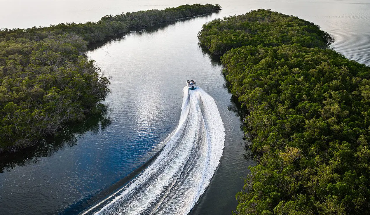 aerial view of a hurricane fundeck boat speeding through a cove